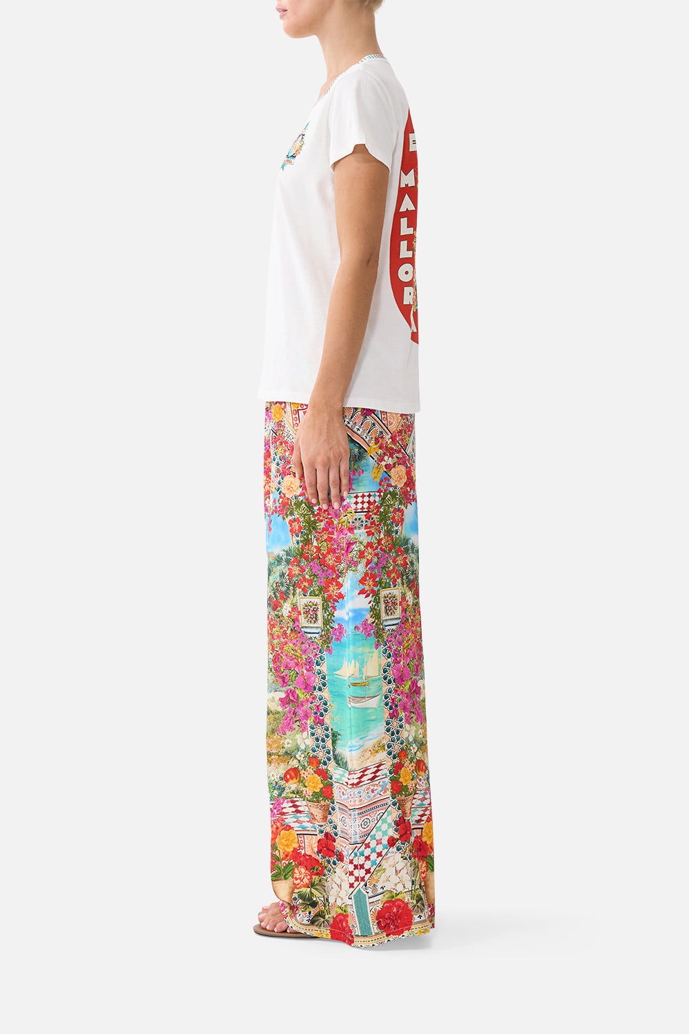 The CAMILLA slim fit round neck t shirt in our print Meet Me in Mallorca. Side model view.