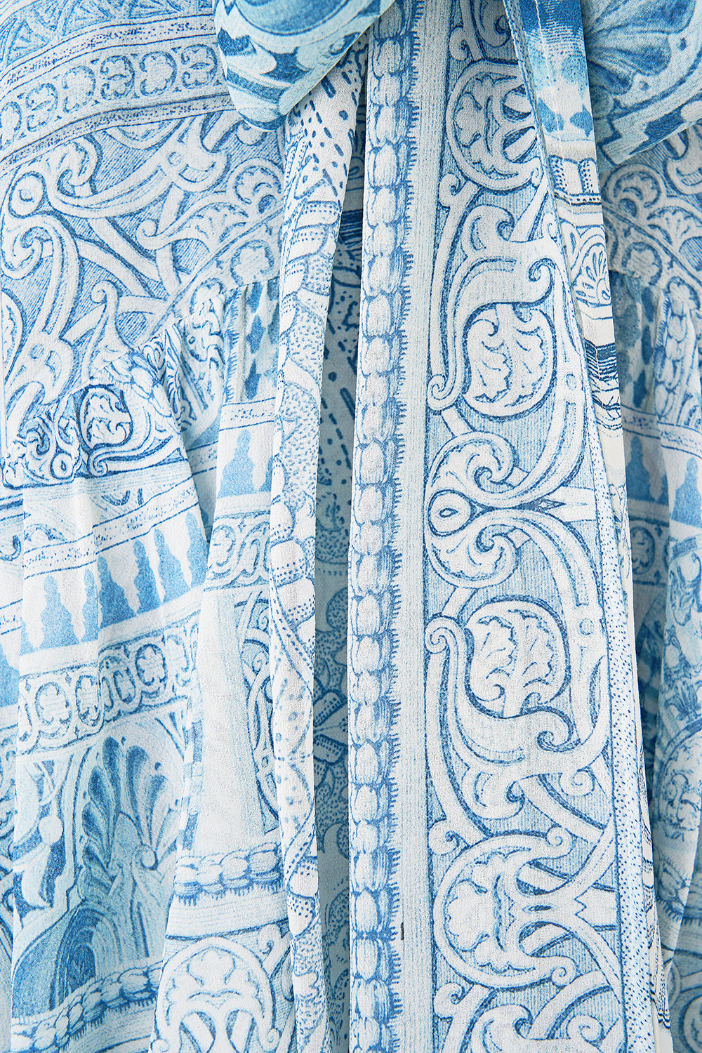 The CAMILLA RUFFLE HIGH LOW DRESS WITH LONG SLEEVE THE HUM OF THE ALHAMBRA in our  print.