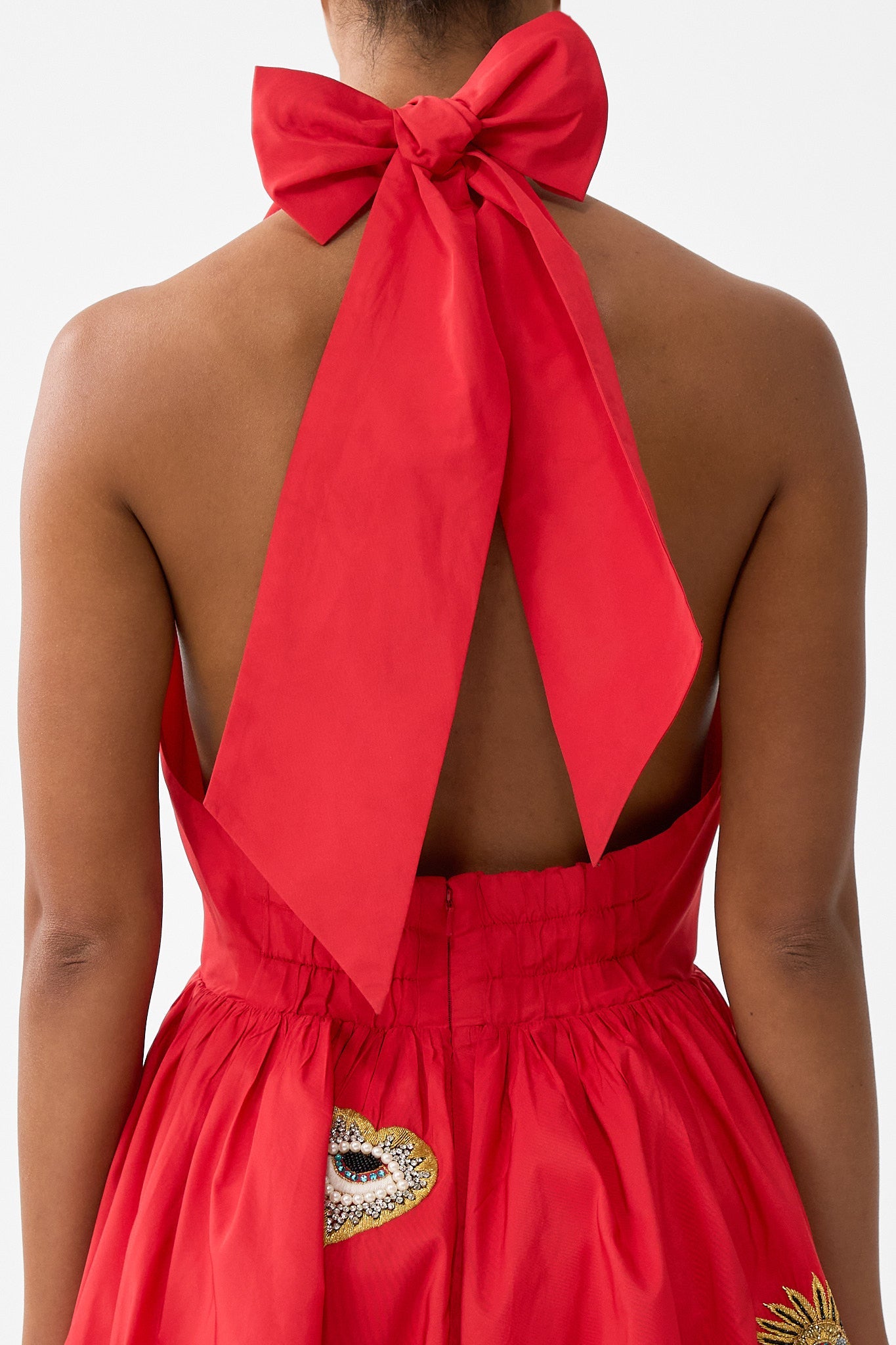 The CAMILLA RUFFLE HEM HALTER SHORT DRESS NAZAR NIRVANA in our  print.