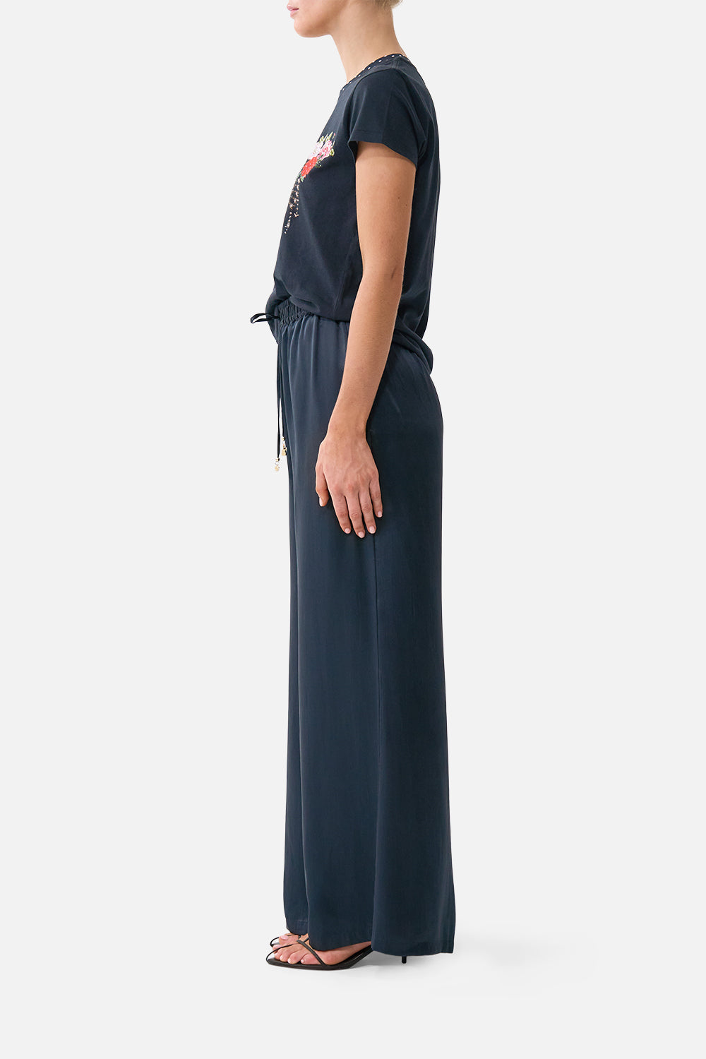 The CAMILLA lounge pant in our print Daughters of Duende. Side model view.