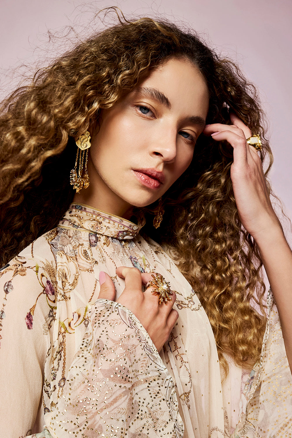 The CAMILLA Palais Aetheria Charm Earrings in gold, worn on model.