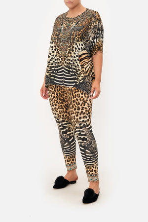 Front view of curvy model wearing CAMILLA plus size leopard print  leggings in For The Love Of Leo print